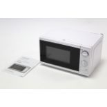 A Tesco 700W microwave oven in white finish case.