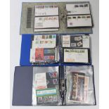 A collection of approximately one hundred various first-day covers, contained in three albums.