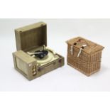 A Monarch fibre-covered portable turntable in fibre-covered case; & a wicker basket.