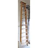 A large pine twelve-rung folding step ladder, 10’ high.