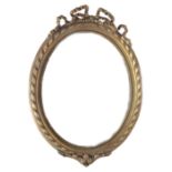 A reproduction large gilt frame oval wall mirror with ribbon-bow surmount & with beaded edge, 51”