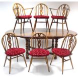 A set of six Ercol elm dining chairs (including a pair of carver chairs), with pierced & carved