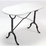 A cast-iron conservatory table on shaped end supports & with white marble top, 47” wide.