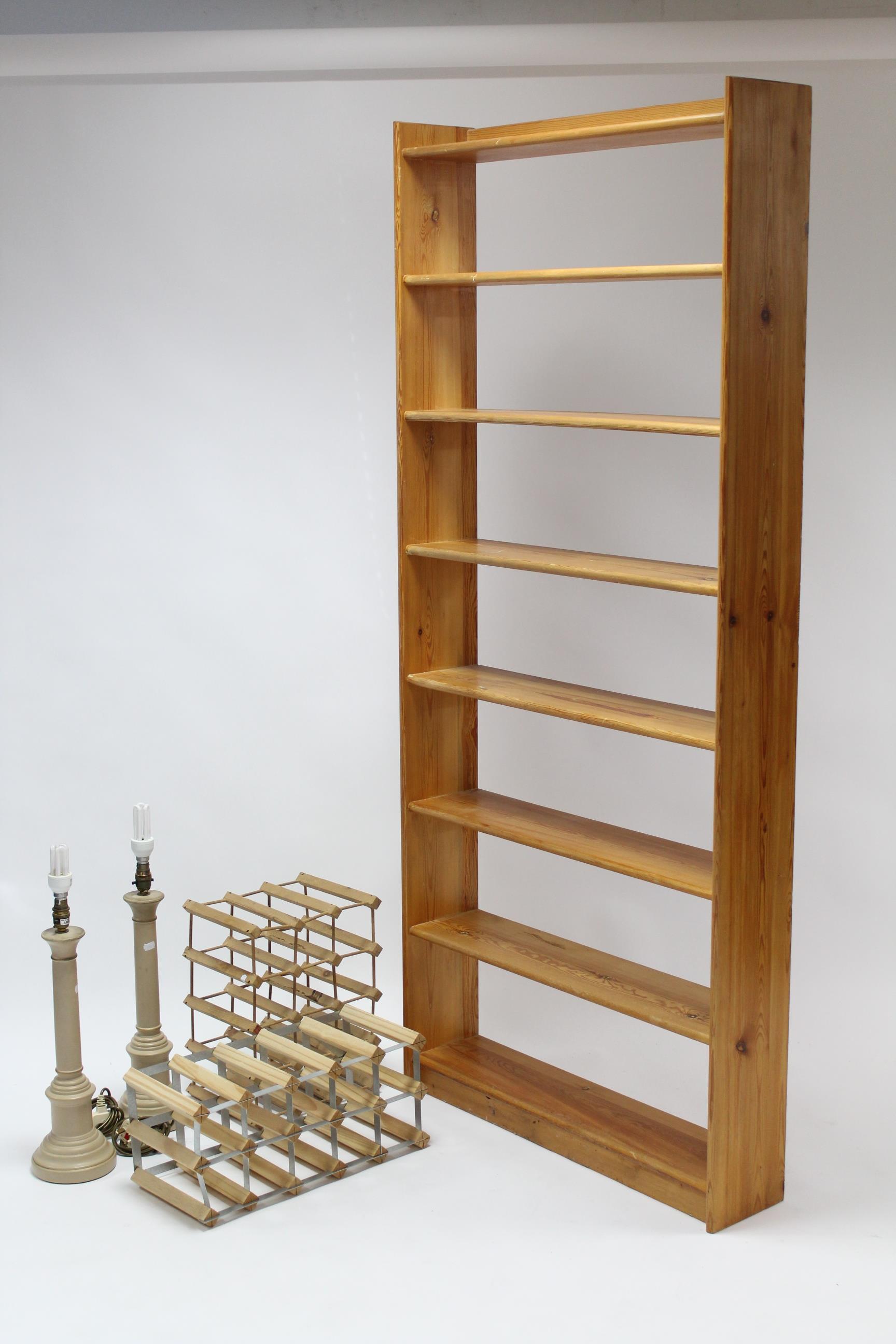 A pine tall standing eight-tier open bookcase, 33” wide x 75” high; together with two wine