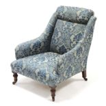 A late Victorian easy chair upholstered pale blue & light grey geometric material, & on short turned