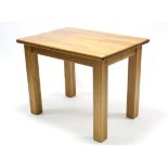 A light oak kitchen table with rectangular top, & on square legs, 39½” x 28”.