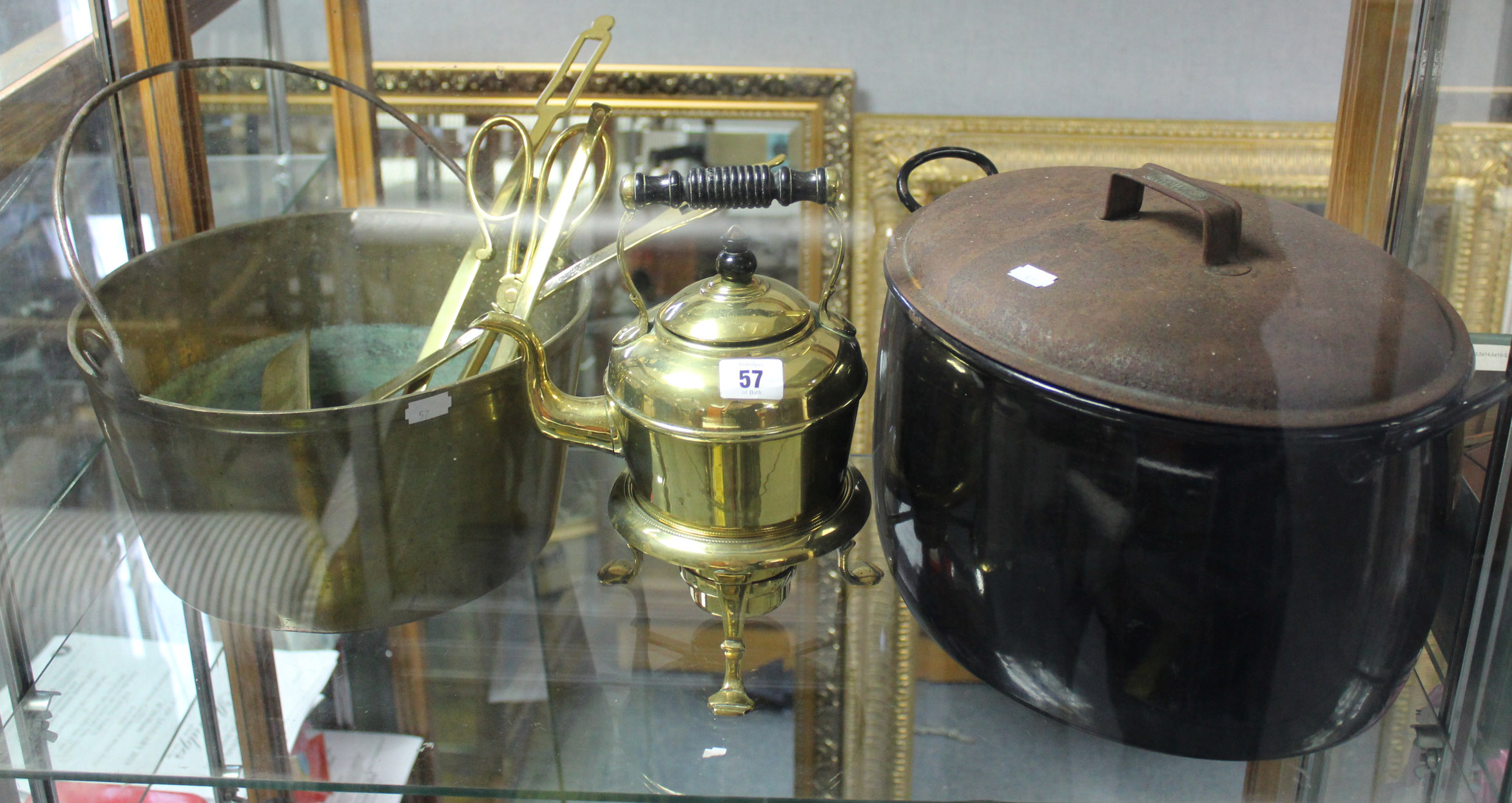 A brass spirit kettle on stand; three brass ladles; a brass preserve pan; & various other items of
