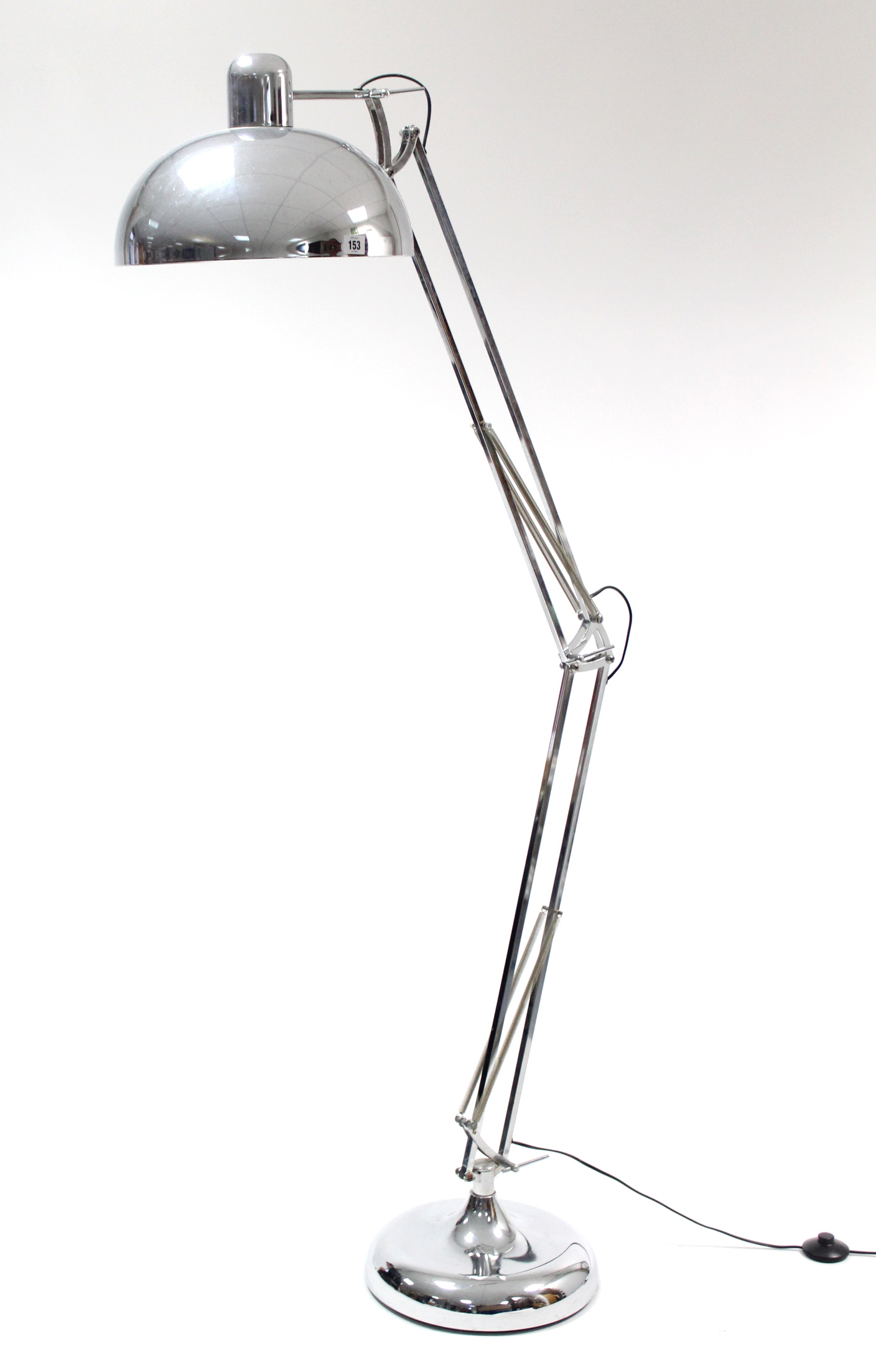 A silvered-metal anglepoise standard lamp.