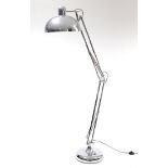 A silvered-metal anglepoise standard lamp.