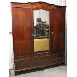 A mid-20th century mahogany wardrobe, enclosed by rectangular mirror door to centre flanked by panel