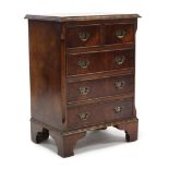 A reproduction bird’s-eye maple small chest, fitted two short & three long drawers with brass