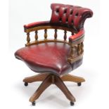 A mahogany & crimson leather swivel office chair on five splay legs.