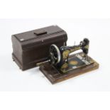 A vintage Jones hand-sewing machine with case.