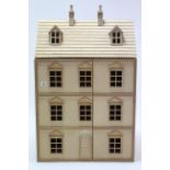 A wooden three-storey doll’s house with opening front, 25” wide x 35” high x 14½” deep.
