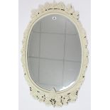 A white painted & carved wooden frame oval wall mirror, 37½” x 24½”; & a composition oval plaque