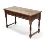 A Victorian mahogany side table, fitted two frieze drawers with brass swing handles, & on baluster-