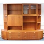 A G-PLAN TEAK TALL INTER-CHANGEABLE WALL UNIT fitted with an arrangement of drawers, cupboards &