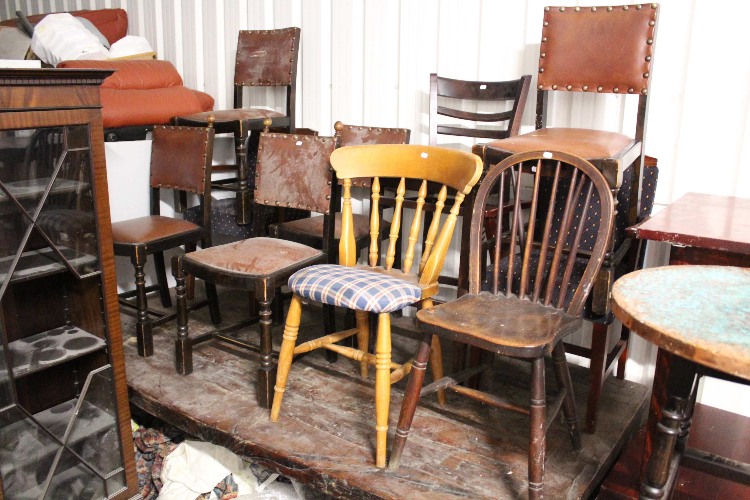 A set of five dining chairs with padded seats & backs upholstered brown leatherette; together with