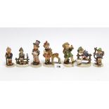Seven Goebel Hummell figures titled: “Friends”, “Joyful Adventure”, “Street Singer”, etc.