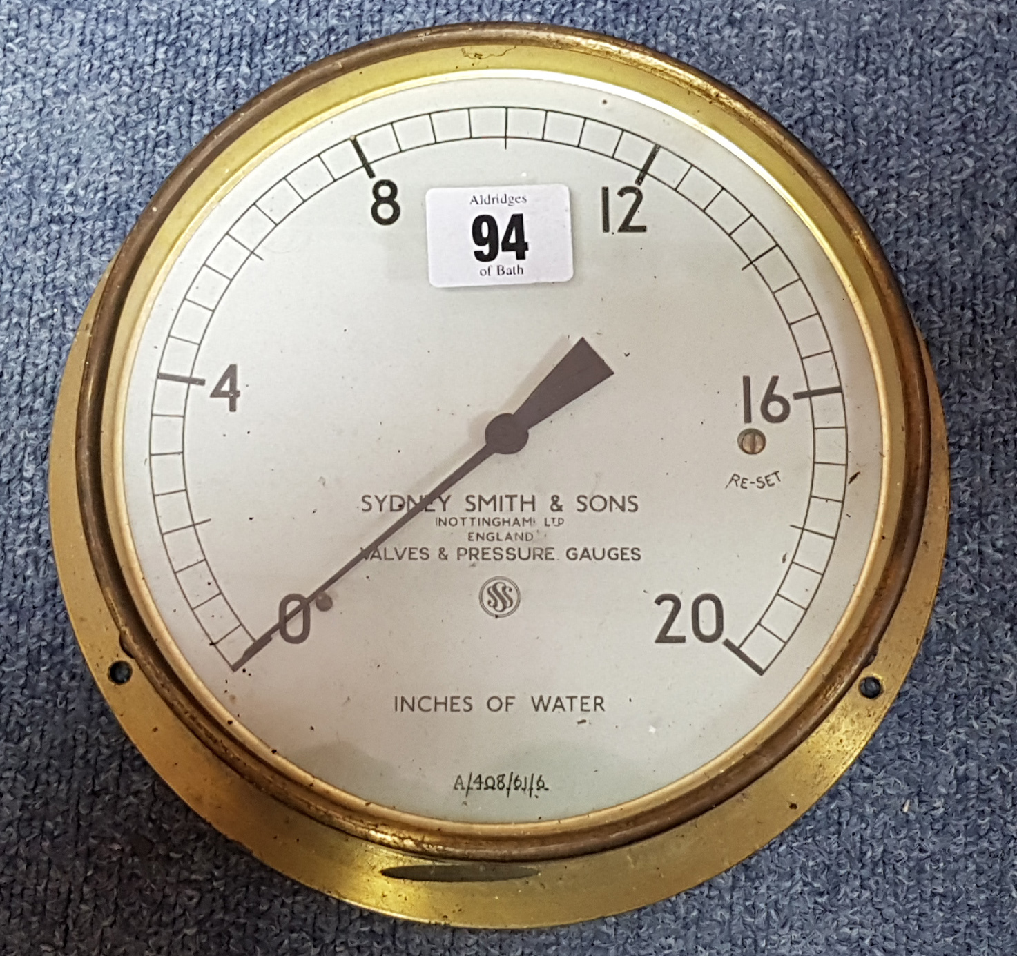 A Sydney Smith & Sons of Nottingham brass cased water pressure gauge, 7” diam.; a Pelaw floral