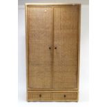 A rattan-covered twin-door wardrobe, 43¼” wide x 69½” high.