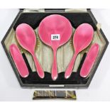 A George V silver & pink enamelled six-piece dressing table set, Birmingham 1931, cased.