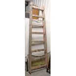 A tall pair of pine folding step ladders, 94” high.