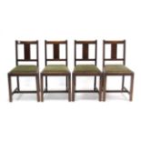 A set of four mid-20th century oak rail-back dining chairs with padded drop-in seats, & on square