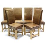 A set of six teak dining chairs with padded backs & sprung seats upholstered brass-studded tan