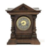 An early 20th century mantel clock with striking movement, & in walnut case, 13½” high.