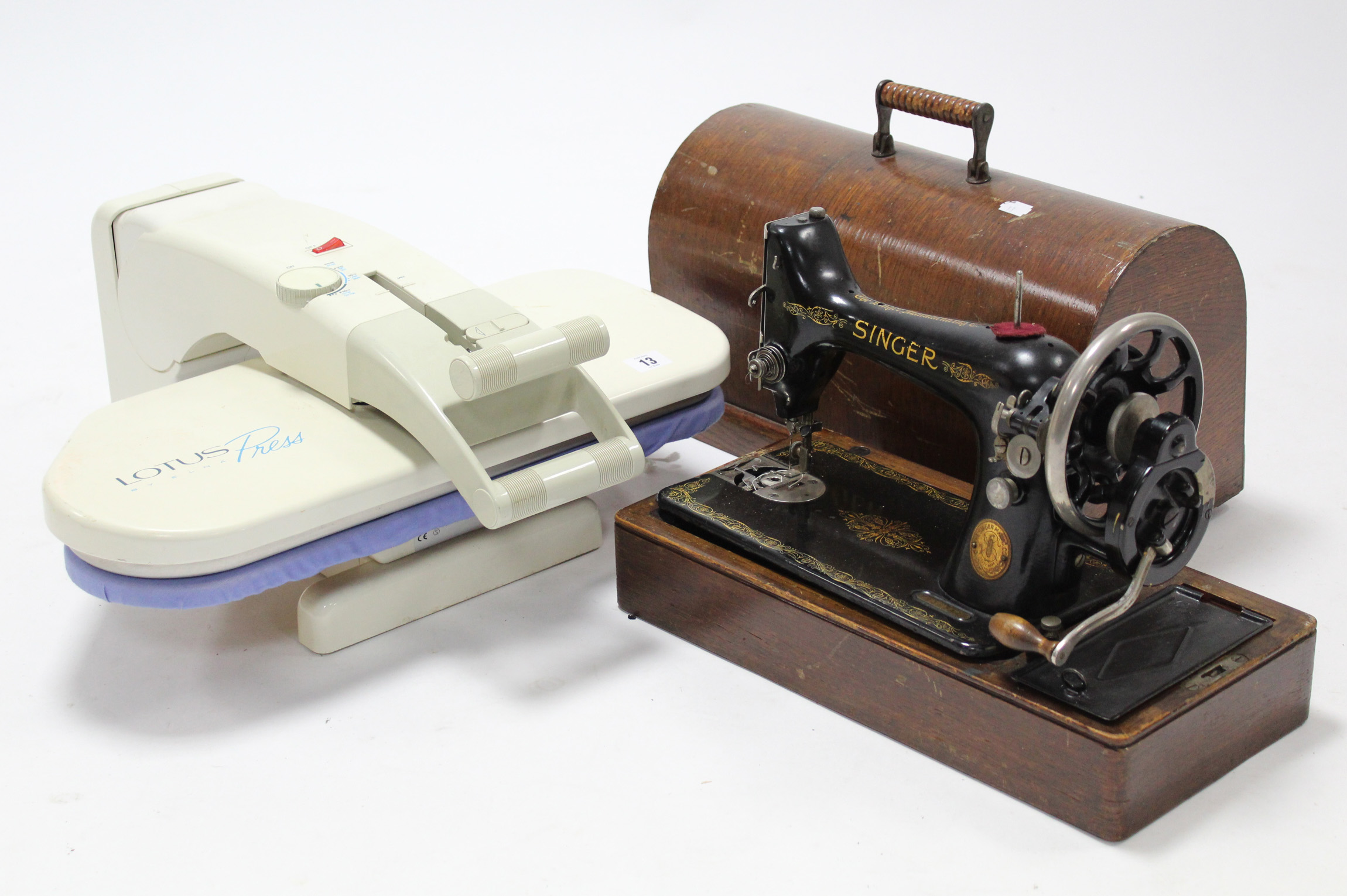 An Elna “Lotus” clothes press, w.o.; & a Singer hand sewing machine with oak case.