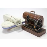 An Elna “Lotus” clothes press, w.o.; & a Singer hand sewing machine with oak case.