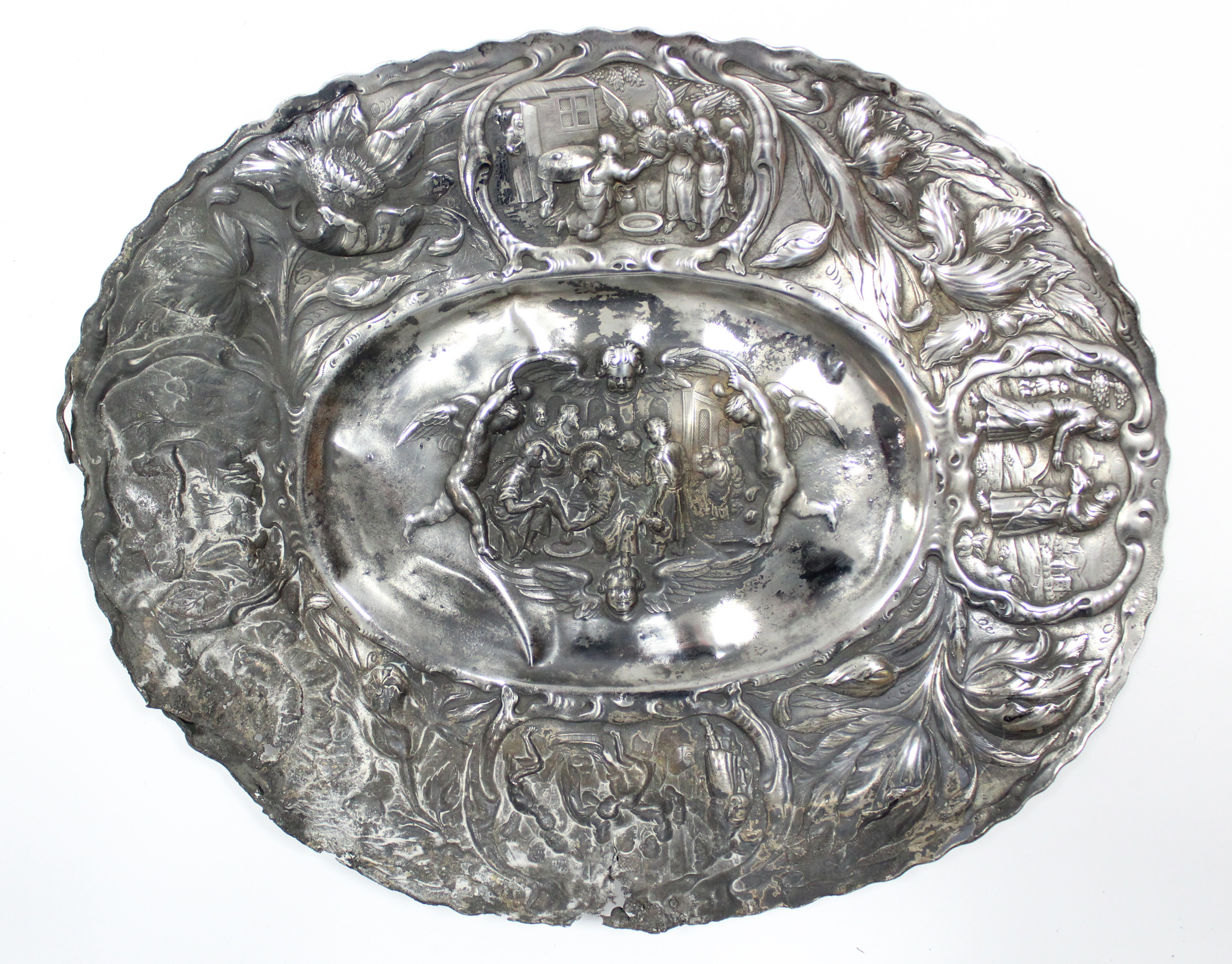 A Dutch oval dish in the 17th century style, the wide border embossed with tulips & vignettes of