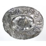 A Dutch oval dish in the 17th century style, the wide border embossed with tulips & vignettes of