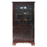 A George III mahogany tall standing corner cabinet, the upper part with Greek-Key cornice, fitted