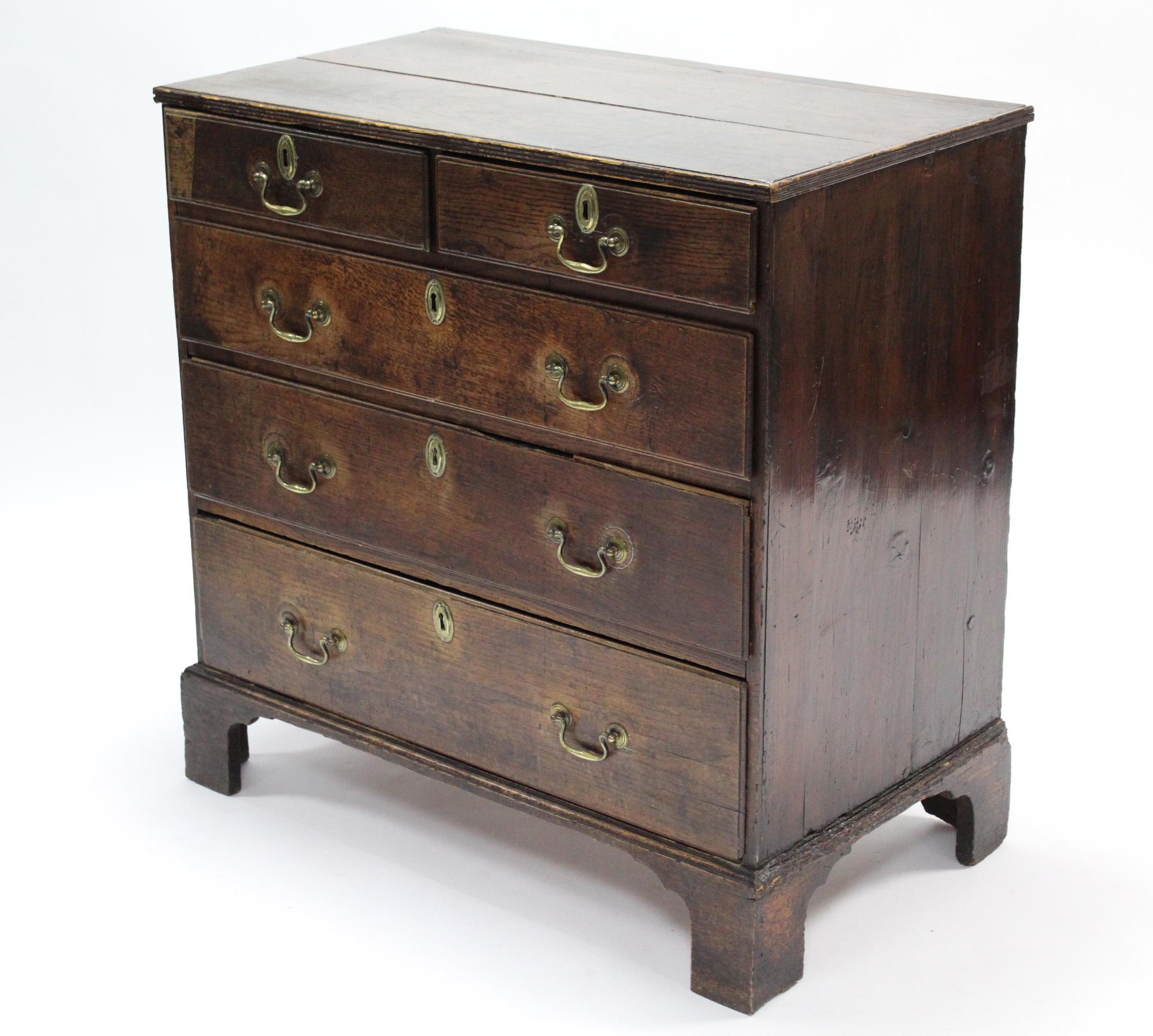 A late 18th century oak chest, fitted two short & three long graduated drawers with brass swan-