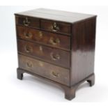 A late 18th century oak chest, fitted two short & three long graduated drawers with brass swan-