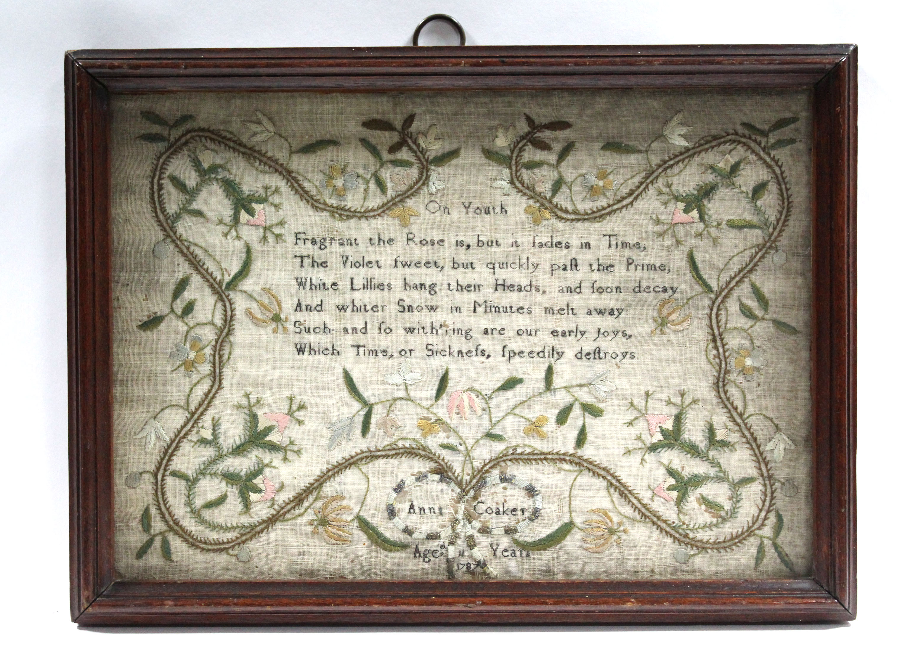 A late 18th century needlework sampler by Anne Coaker, aged 11 years, with verse within a meandering