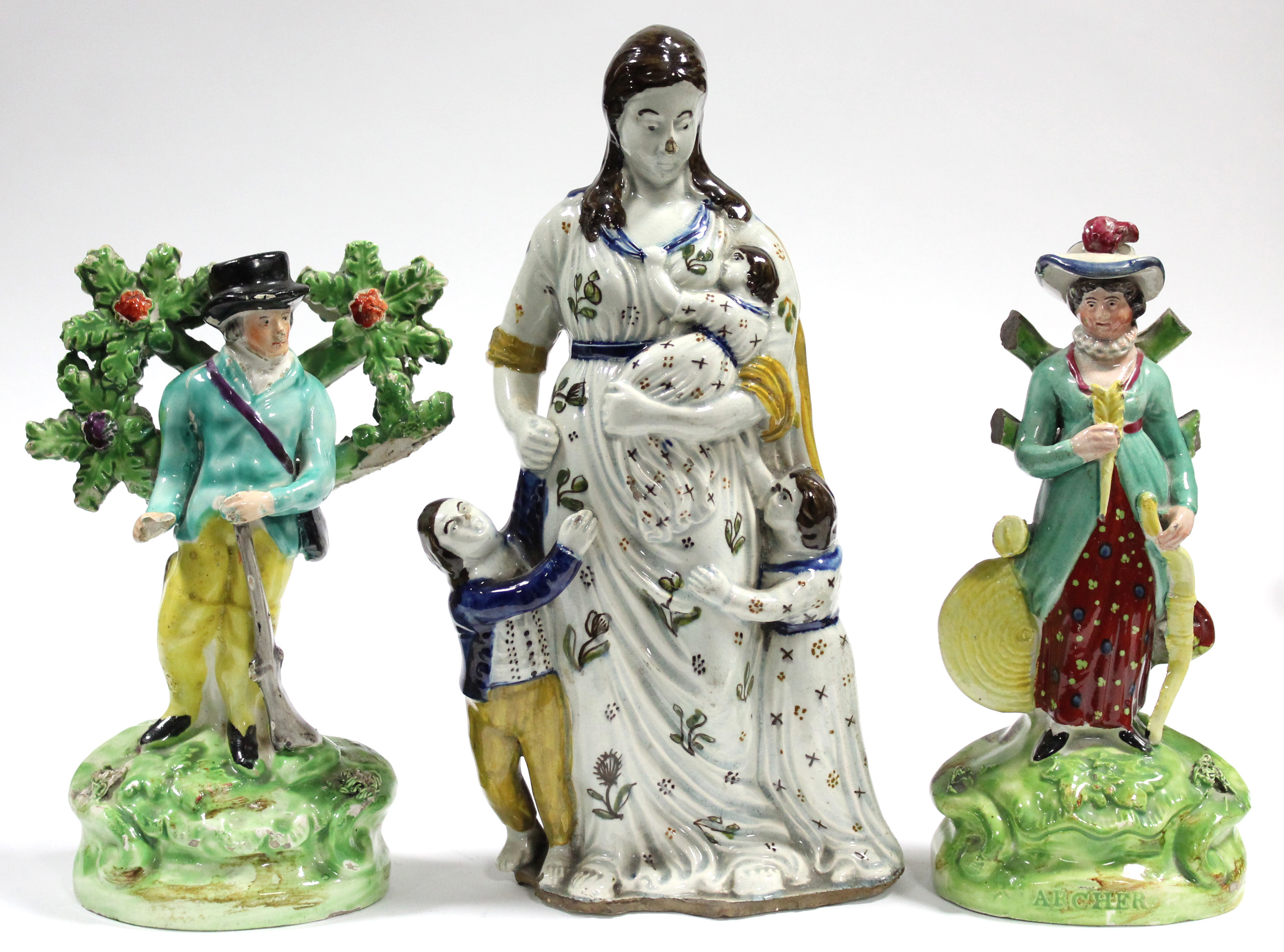 An early 19th century Staffordshire pearlware standing figure of a sportsman with his rifle, on oval