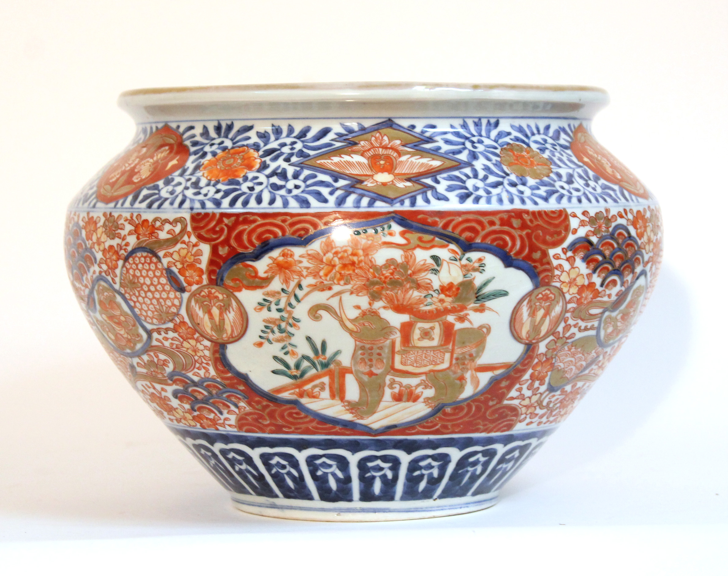 A Japanese Imari porcelain jardinière of squat round form, decorated with elephants in reserves, 12”