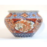 A Japanese Imari porcelain jardinière of squat round form, decorated with elephants in reserves, 12”