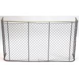 A Victorian brass-rail & wire mesh nursery fire guard; 49” wide x 27” high.