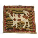 An early 19th century petit-point wool needlework panel depicting a spaniel, 11½” x 13½”; a