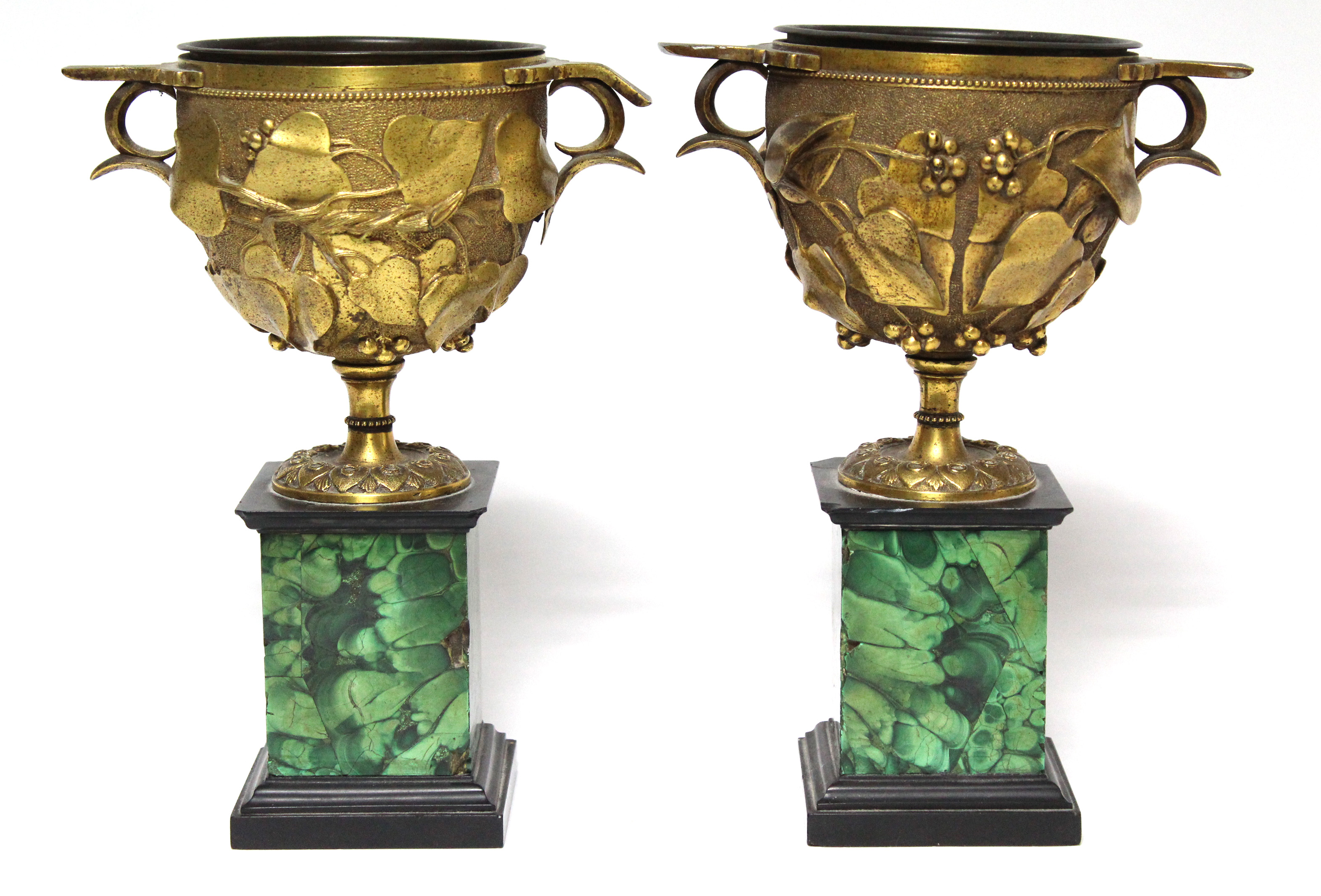 A pair of 19th century ormolu Roman-style urns, each with fruiting vine decoration, on malachite