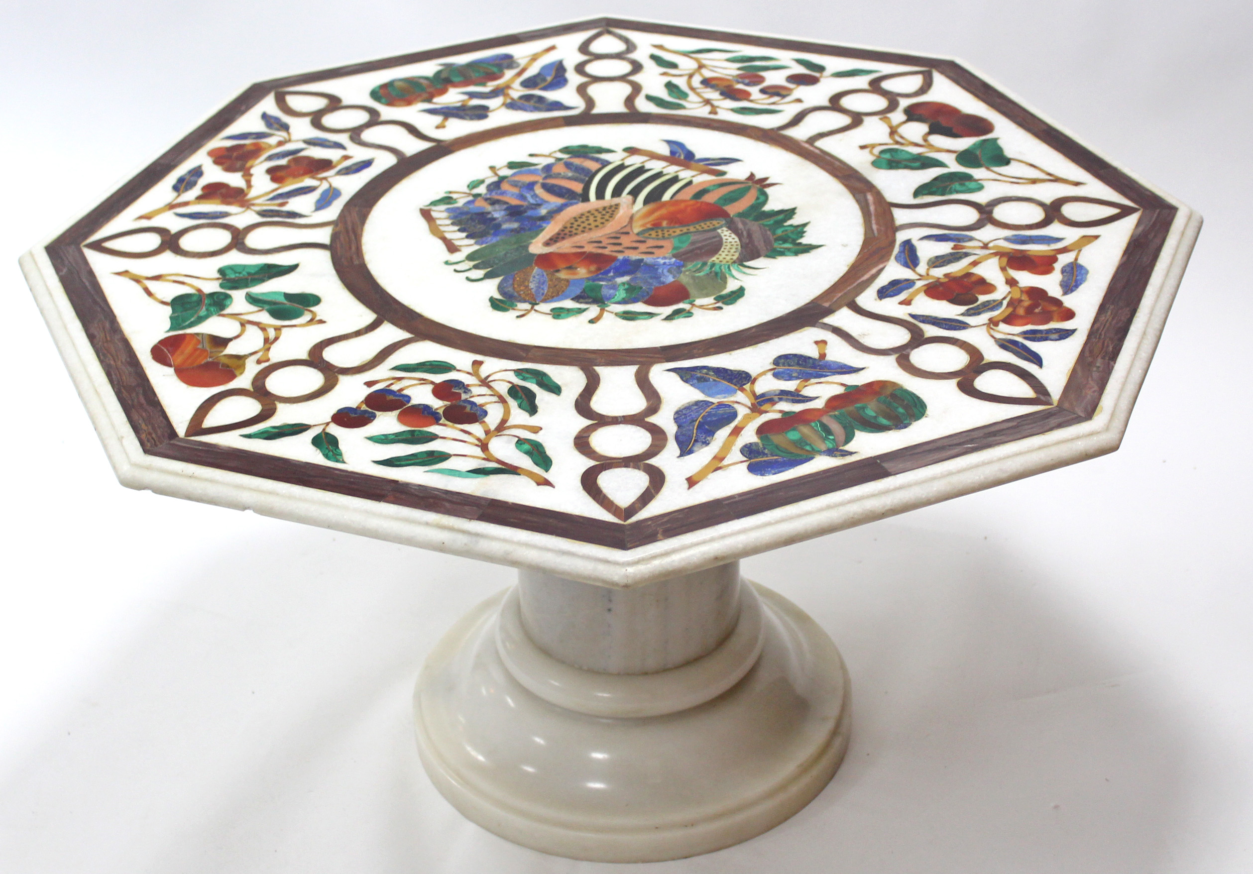 A 20th century Pietra Dura octagonal marble low table, decorated with exotic fruit in coloured