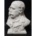 A late 19th century sculptured white marble bust in profile of a gentleman wearing monocle & with