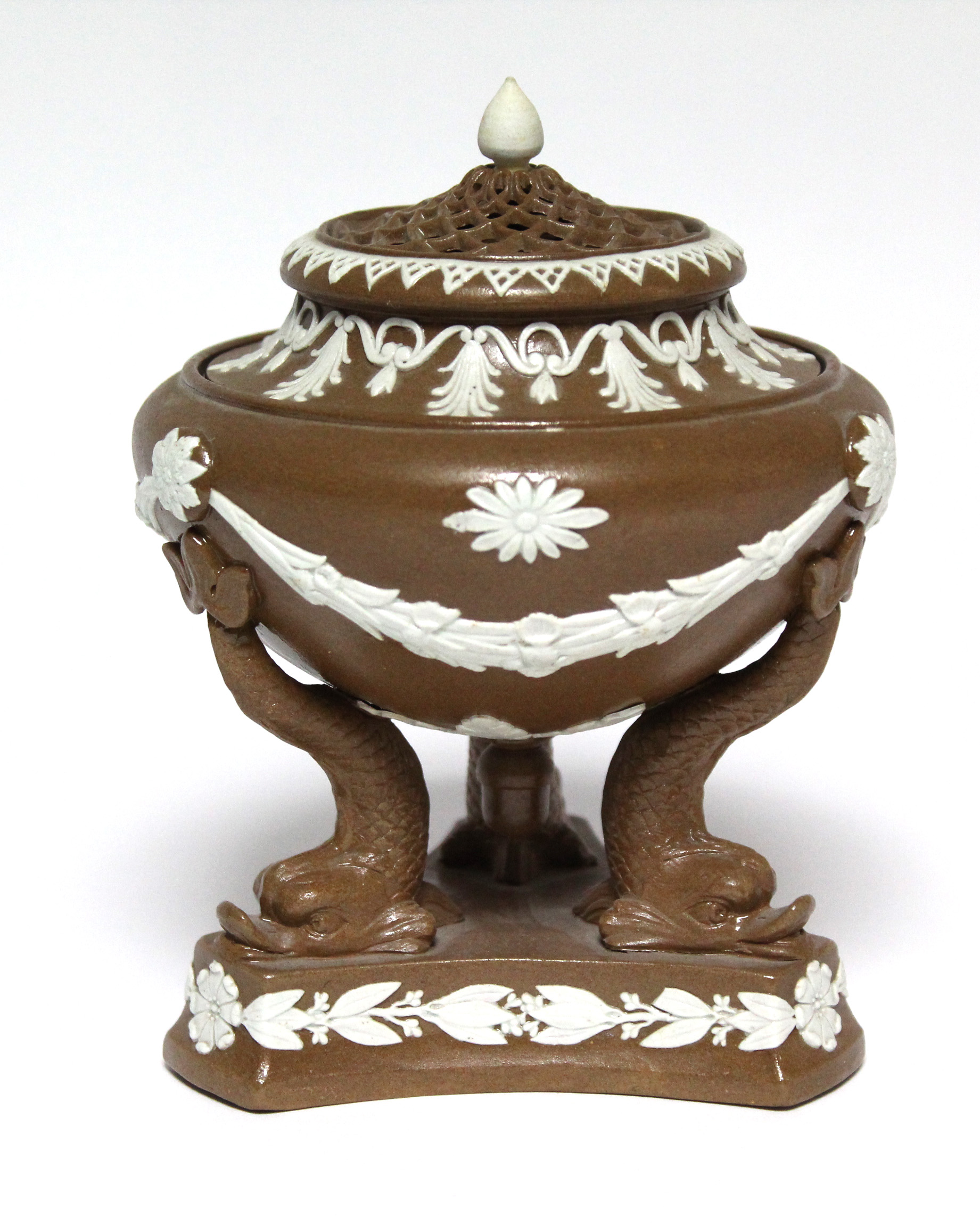 A buff-ground pot pourri vase of classical urn design with applied white swags & anthemions, pierced