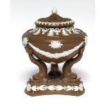 A buff-ground pot pourri vase of classical urn design with applied white swags & anthemions, pierced