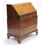 AN 18th century ELM BUREAU in two sections, the upper part fitted frieze drawer below the sloping