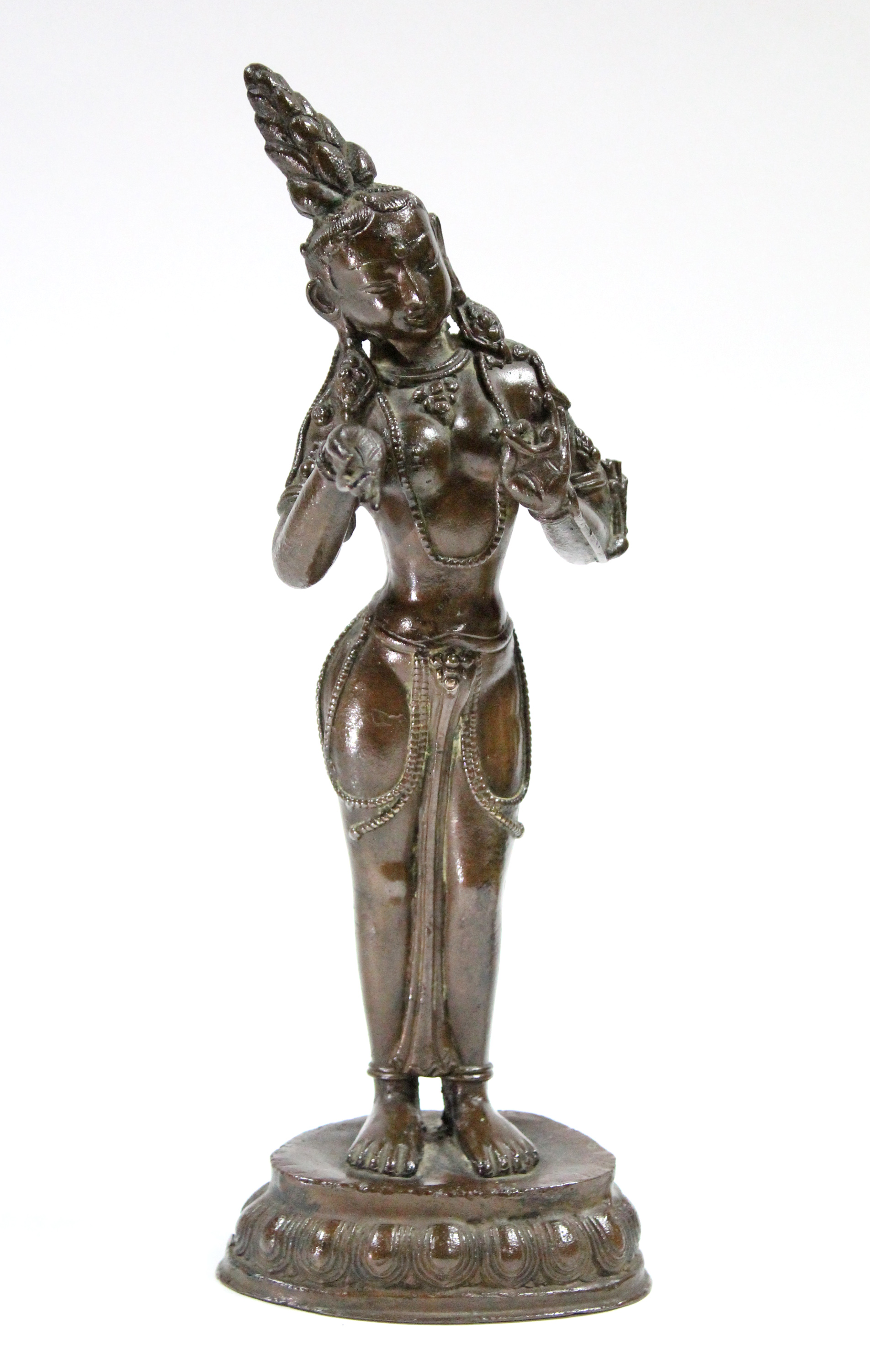 A Sino-Tibetan bronze standing figure of a Bodhisattva, with head tilted to the right, hands